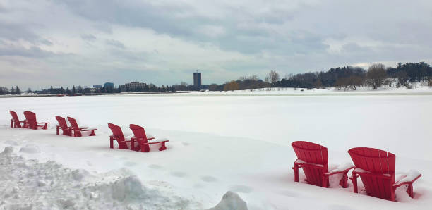 Winter view of the iconic Red Chairs of Park Canada buried under heavy snow at Dows Lake in Ottawa,Ontario,Canada