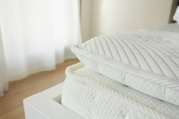 istock Bed with white orthopedic mattress in a room. 2198559726