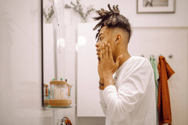 istock At home - young man brushing his teeth 2198561091