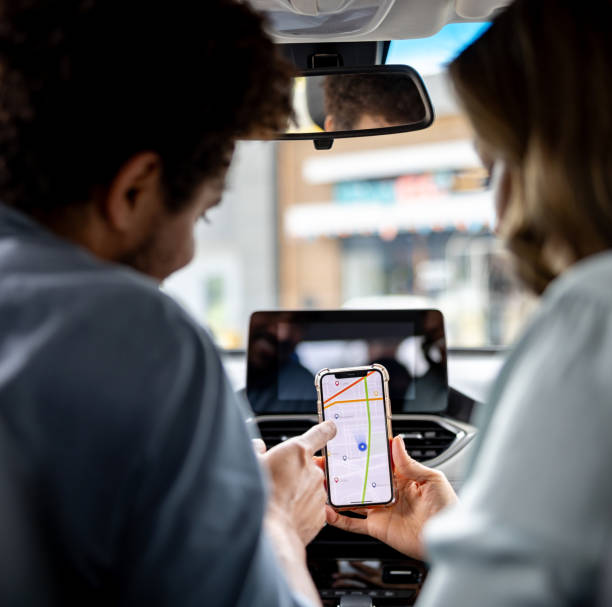 istock Couple using their GPS app to plan their car ride 2198562594
