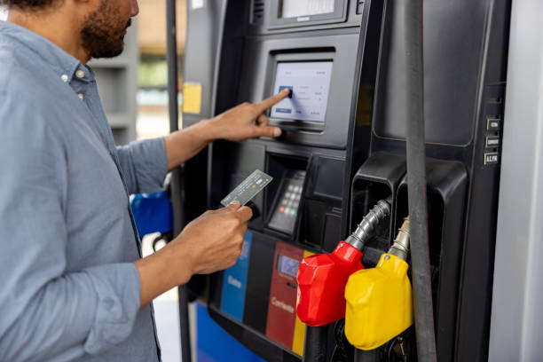 Close-up on a man paying by card at a gas station after refueling his car