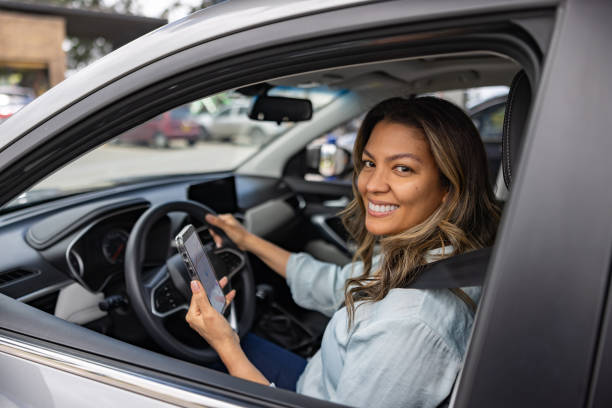 istock Happy woman in her car using a navigation app to plan her ride 2198562652