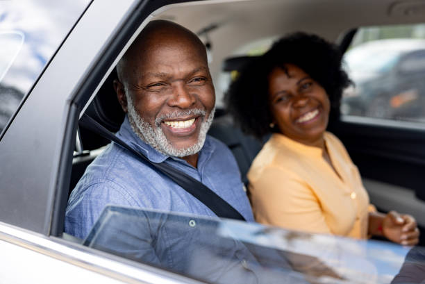 istock Senior passengers in a crowdsourced taxi smiling through the window 2198562668