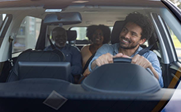 istock Crowdsourced taxi driver talking to his passengers in the back seat 2198562670