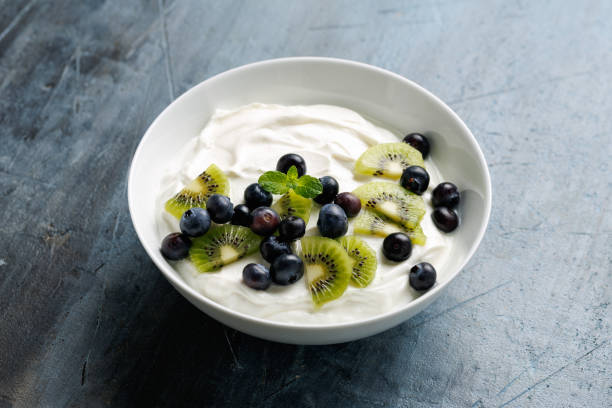 istock Greek yogurt with fresh blueberries and kiwi. Probiotic healthy food breakfast 2198564642