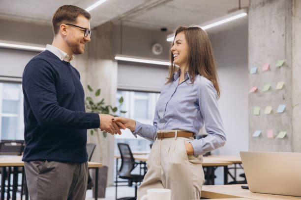 istock Business professionals greeting with firm handshake after sealing important contract, exhibiting workplace partnership and mutual success 2198565384