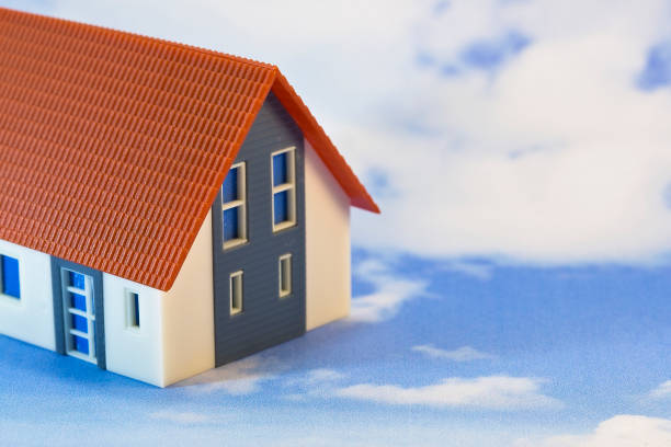 istock The dream house - Concept with home model against sky 2198565558