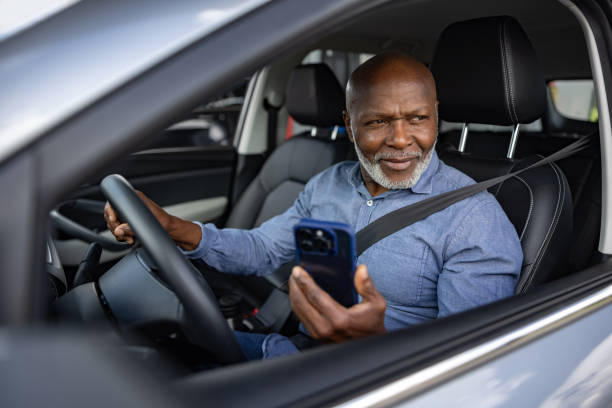 istock Senior driver in his car using a navigation app on his cell phone 2198565853