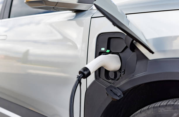 istock Close-up on a plug connected to an electric car while charging 2198565873