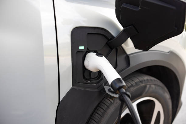 istock Electric plug connected to an alternative fuel vehicle 2198565894