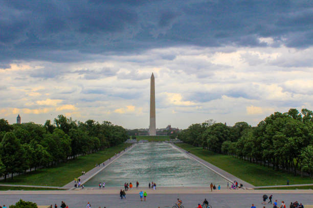 Cloudy skies hover over the National Mall with many visitors around.