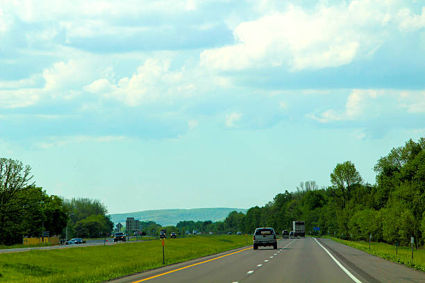 istock Scenic highway with cars driving under a blue sky 2198566762