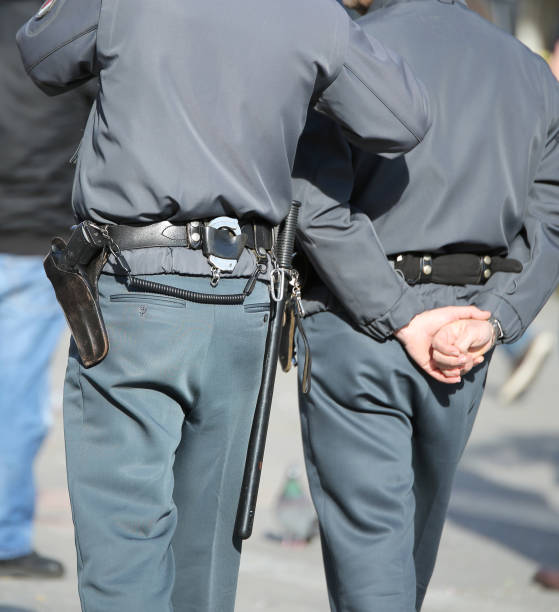 istock two cops with uniform and handcuffs in the city 2198567216