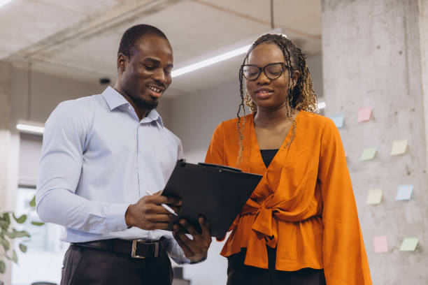 istock Two business colleagues reviewing notes on clipboard during a productive workday in the office 2198567972