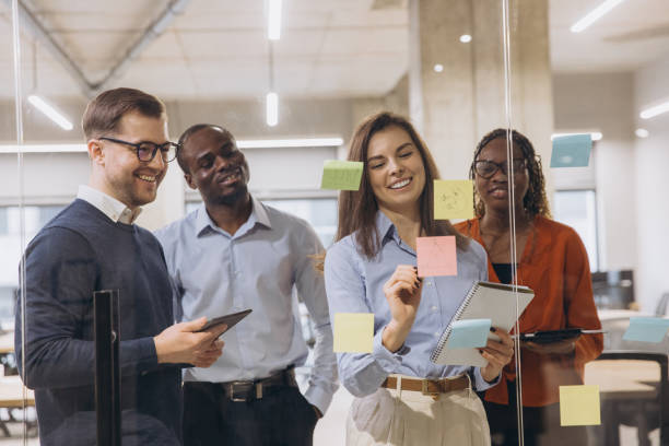 istock Group of professionals brainstorming in a contemporary office, using sticky notes and tablets for creative business planning and teamwork 2198568248