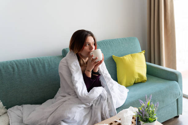 istock Sick young woman drinking at home 2198568633