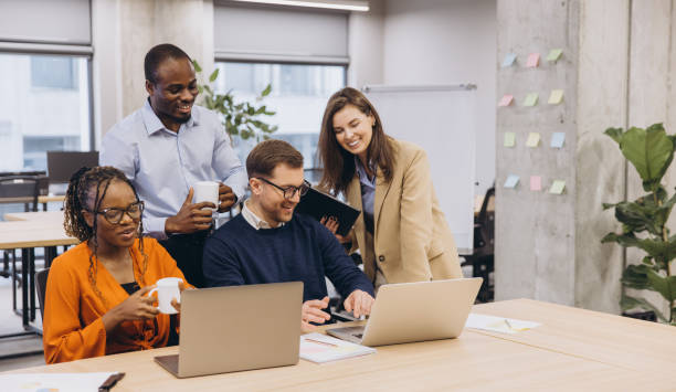 istock Professionals collaborating during brainstorming meeting, sharing ideas in contemporary workspace with diverse team members working together 2198570715