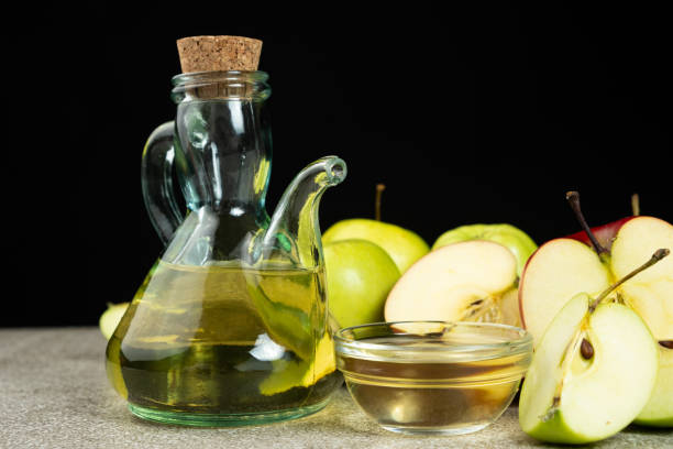istock Apple cider vinegar in a glass vinegar bowl among apples 2198571244