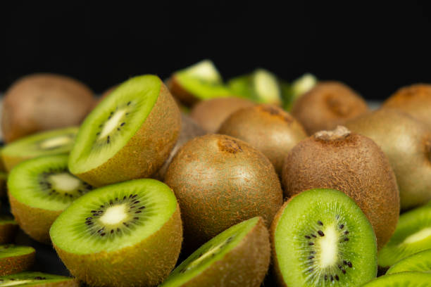 istock Fresh kiwi fruit, many whole and sliced kiwi 2198571253