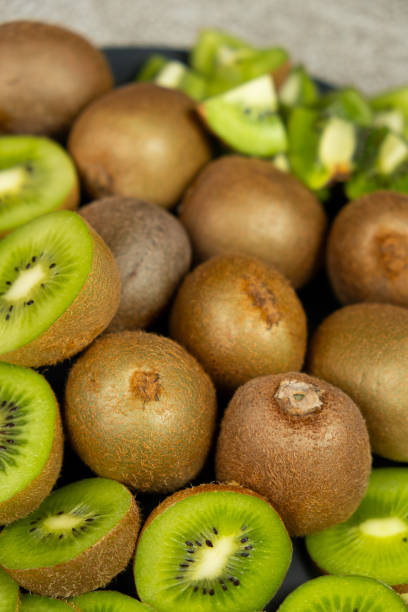 istock Fresh kiwi fruit, many whole and sliced kiwi 2198571254