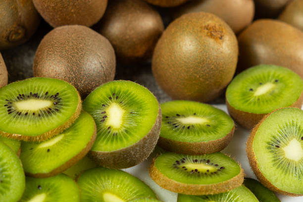 istock Fresh kiwi fruit, many whole and sliced kiwi 2198571256