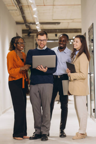 istock Diverse colleagues working together, sharing ideas and using technology to achieve common goals in a modern workspace 2198573299