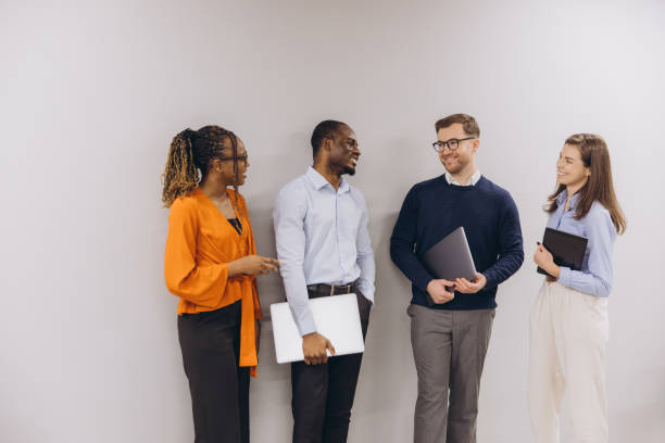 istock Four professionals engage in a lively discussion, showcasing diversity and collaboration in a modern business environment 2198573599