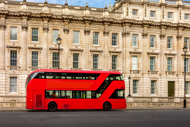 Red double-decker bus on Whitehall street, London, UK