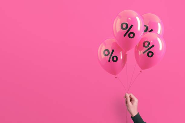 istock A hand holds a cluster of four pink balloons 2198578971