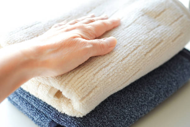 istock Woman touching fluffy towel on white background 2198579015