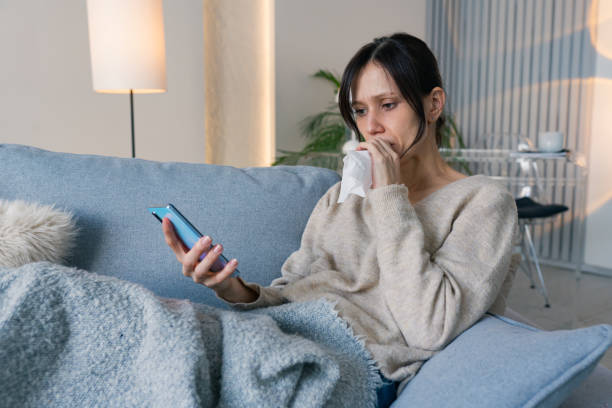 istock Young woman suffering from cold and flu 2198580347