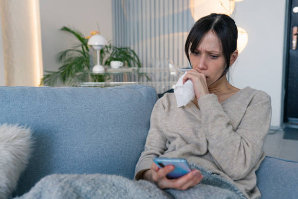 istock Young woman suffering from cold and flu in home 2198580384