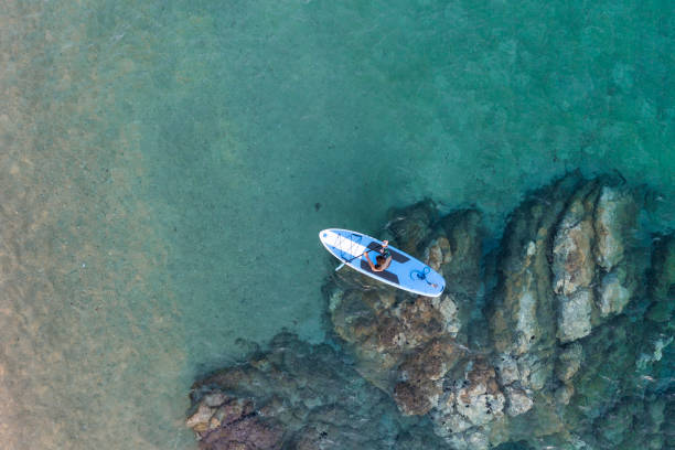 istock Young man driving stand up paddle board at the sea 2198581551