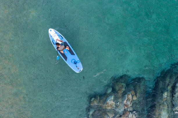 istock Young man driving stand up paddle board at the sea 2198581560