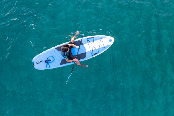 istock Young man driving stand up paddle board at the sea 2198581578