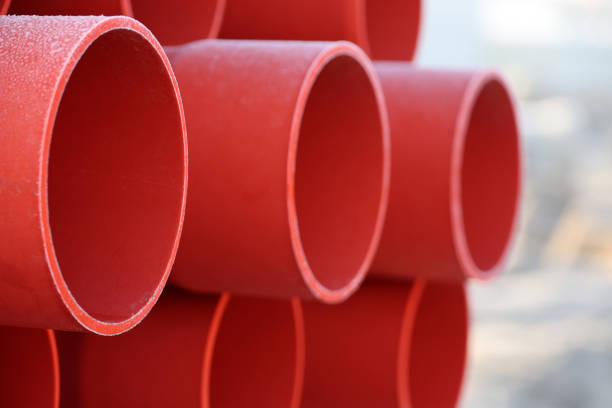Red plastic pipes for underground cables for electricity at a construction site in Zevenhuizen in the Netherlands