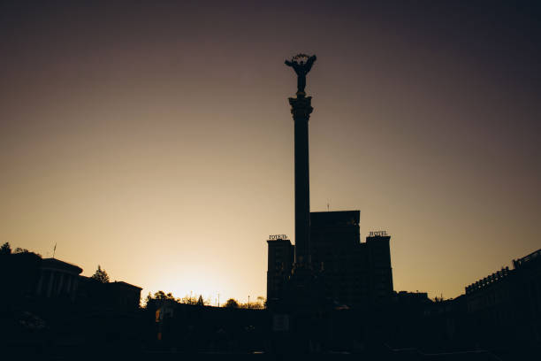 Independence Square framed by a warm, setting sun, creating a striking silhouette.