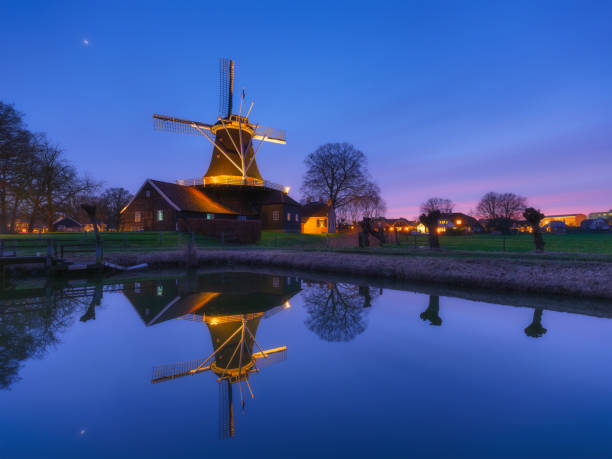 istock Windmill in the Netherlands. Old historical buildings. Architectural landscape. Postcard view. Dutch canals. Reflections on the surface of the water. Photography for design and wallpaper. 2198583698