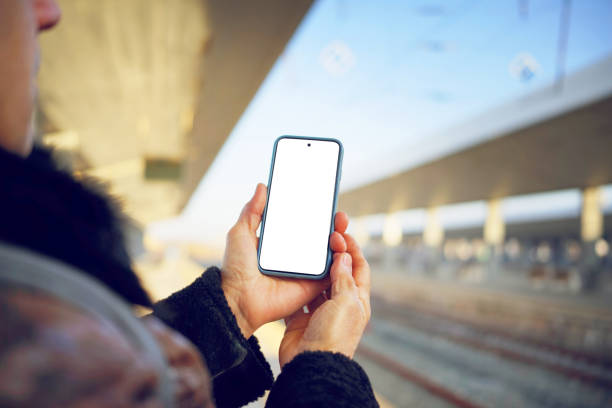 istock Looking at a Smartphone at a Train Station 2198585008