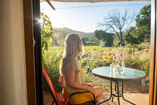istock Woman Relaxing with Water on Vineyard Patio 2198586048