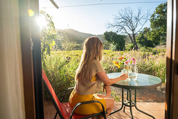 istock Woman Relaxing with Water on Vineyard Patio 2198586052