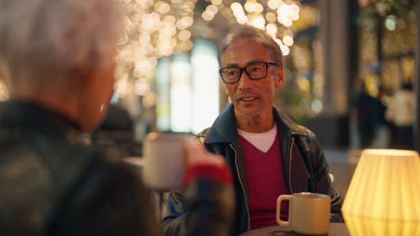 istock Senior Couple Enjoying Warm Drinks - Over the Shoulder View 2198586157