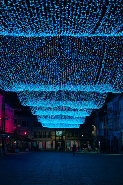 istock Bright blue LED string lights suspended above a city street at night 2198586520