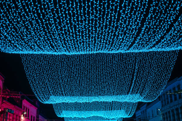 istock Bright blue LED string lights suspended above a city street at night 2198586716
