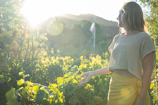 istock Woman Enjoying a Sunny Day in a Vineyard 2198586728