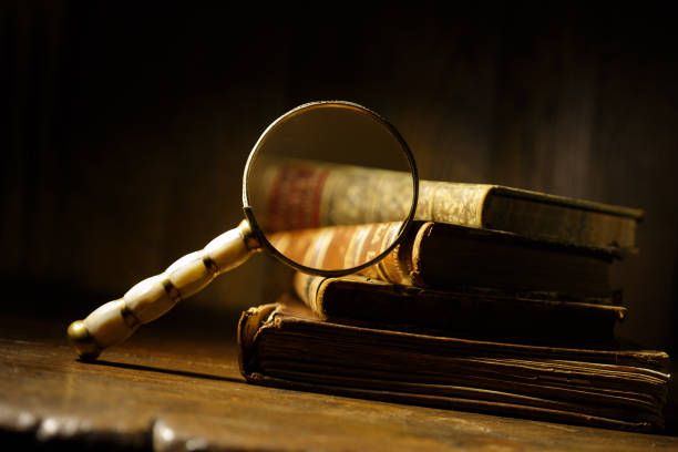 istock Antique books with magnifying glass. Concept for learn history, investigation, find artifacts. 2198586858
