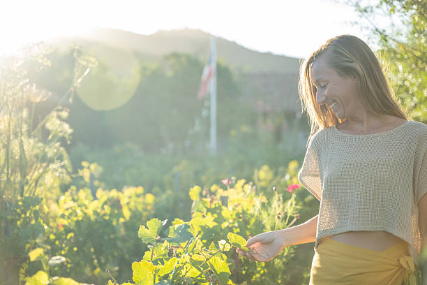 istock Smiling Woman Enjoying a Sunlit Vineyard 2198587465