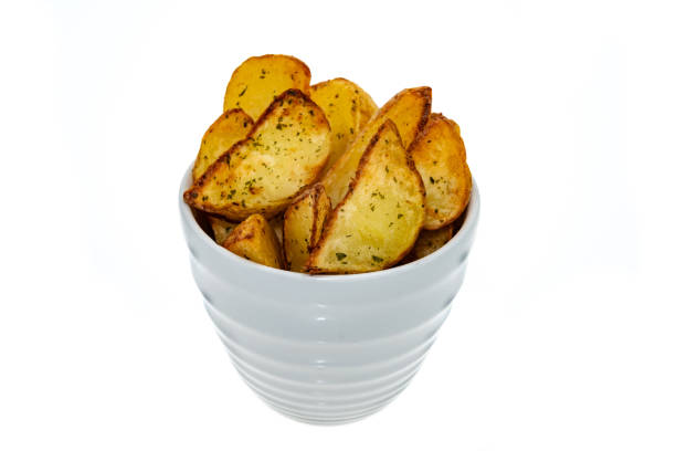 Baked potato wedges in a bowl - white background