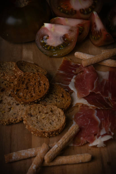 istock Fresh food jamon,bread and tomatoes laid out on a board 2198588512