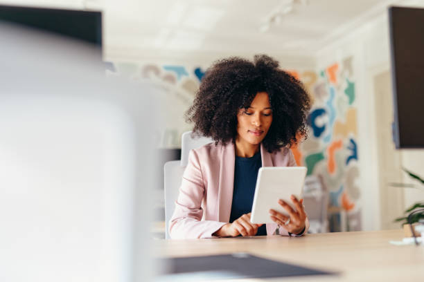 istock Young businesswoman using digital tablet in modern office 2198589485